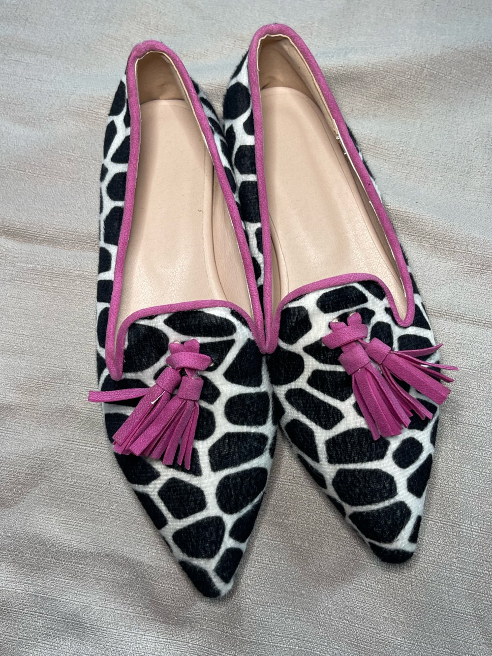 Pointed Giraffe-Print Flats with Pink Tassel Trim